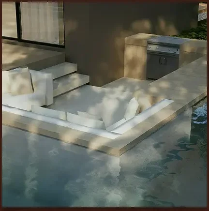 Swimming pool with submerged stone steps and a raised deck