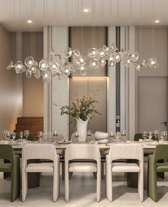 Dining table beneath a sculptural glass-bubble chandelier