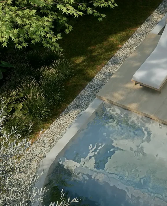 Aerial view of a garden pathway beside a pool and sun loungers