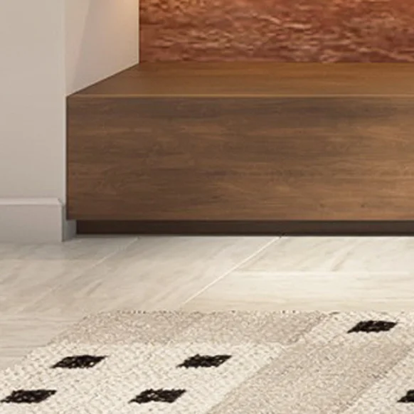 Timber stair tread meeting a patterned wool rug