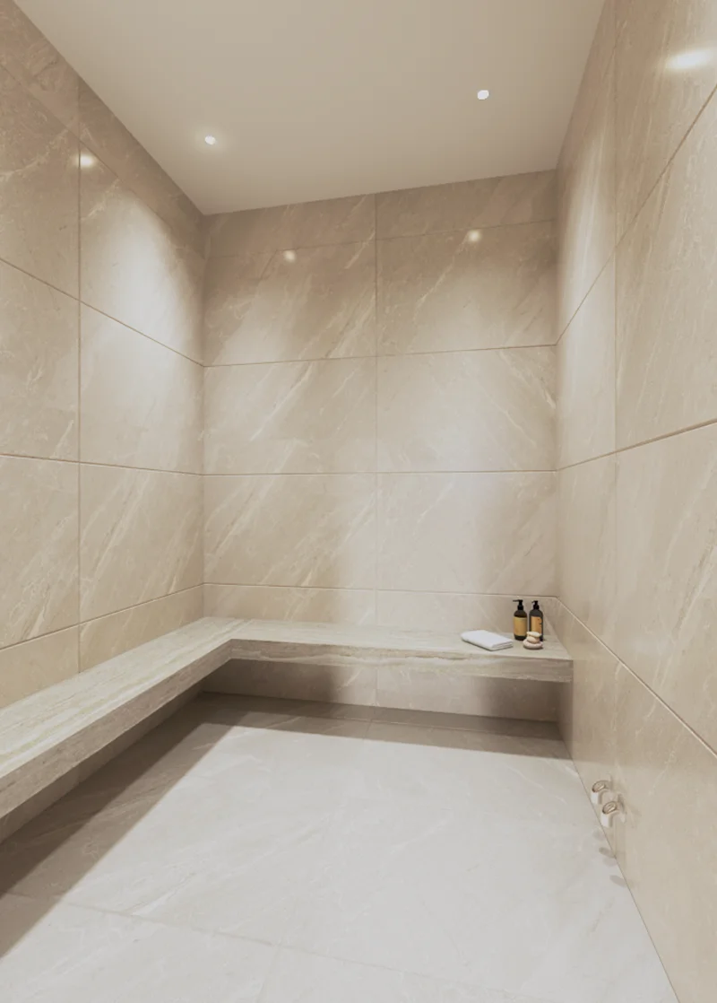 Steam room clad in beige marble with a built-in stone bench